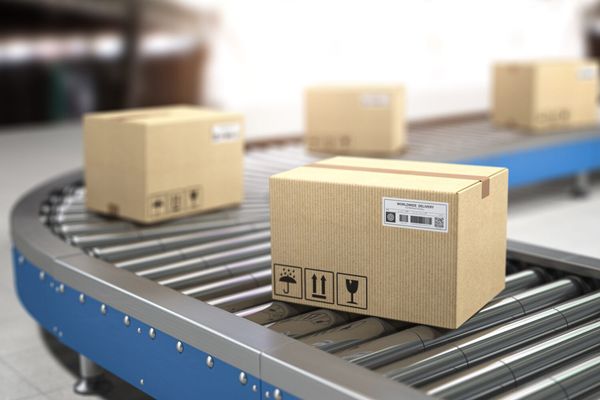 Сardboard boxes on conveyor in warehouse